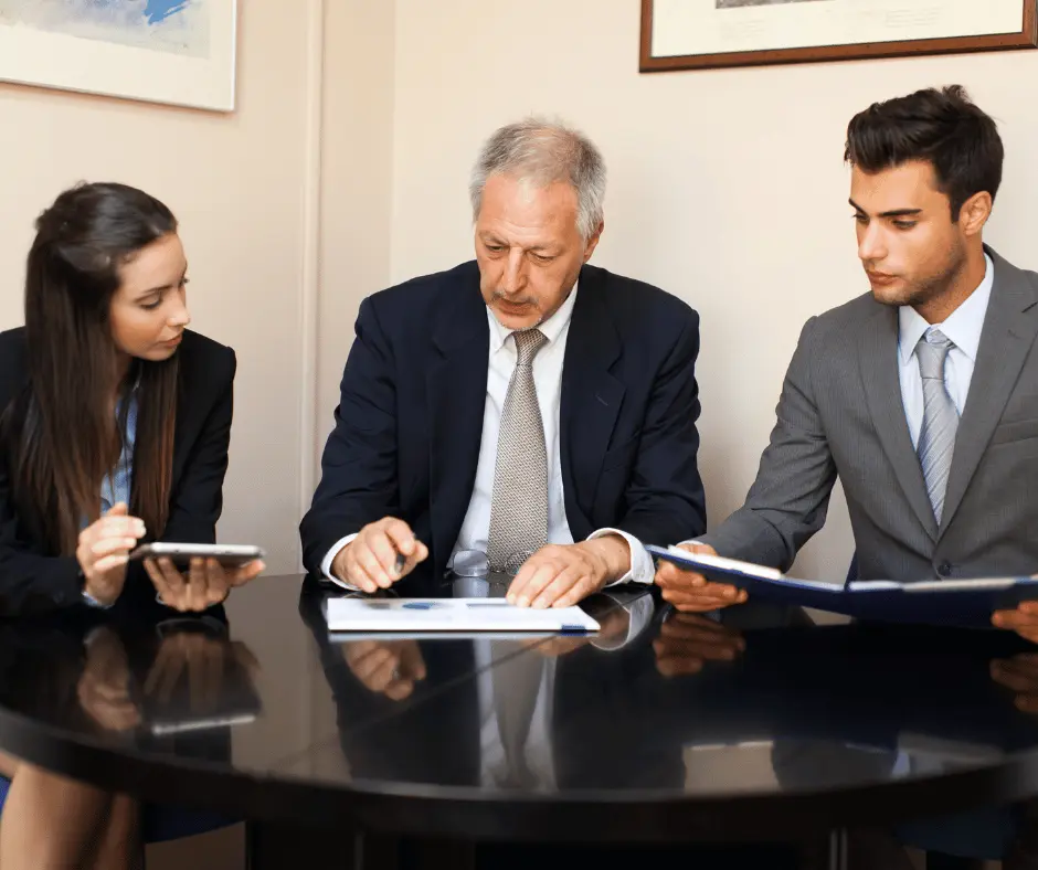  A man and woman seated at a table, discussing legal matters at Fajloun Legal Service.