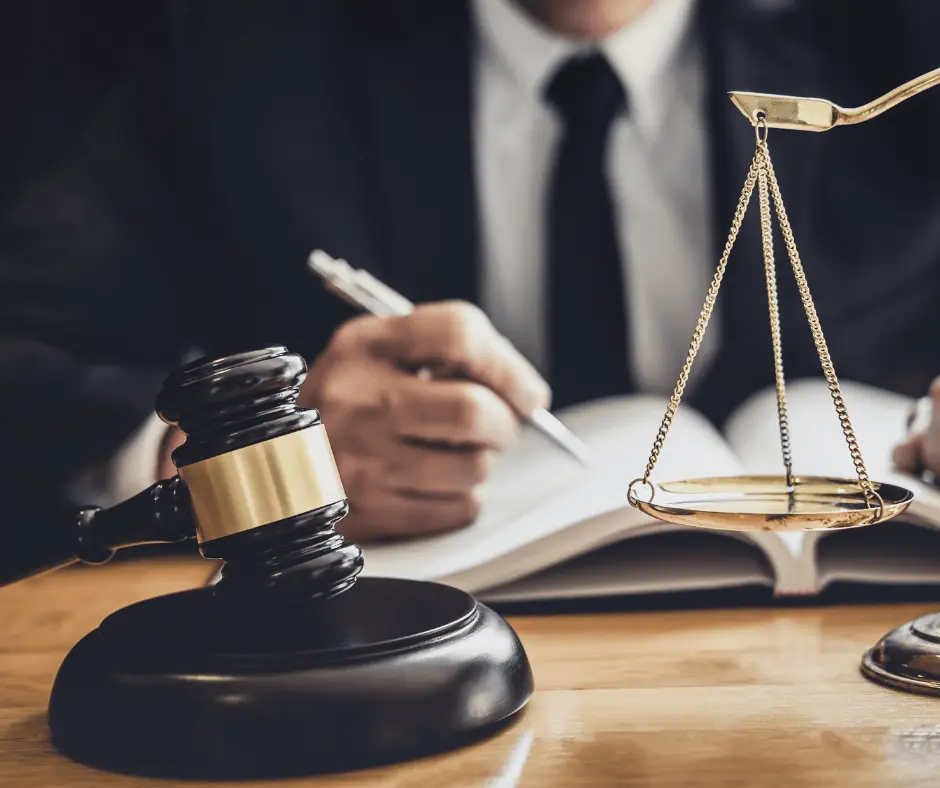 A lawyer and judge positioned at a desk, accompanied by scales of justice and a legal book, illustrating Fajloun Legal Services.